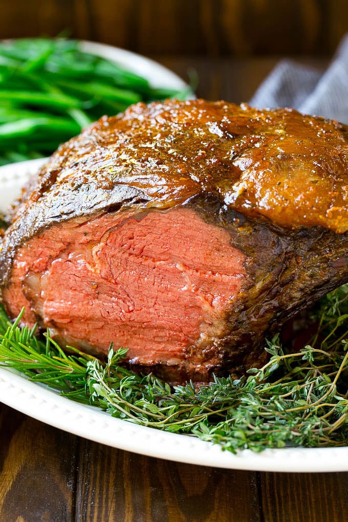 Smoked Prime Rib Recipe | Easy Prime Rib | Smoked Beef | Holiday Prime Rib #primerib #beef #smoker #dinner #ezlod #christmas #thanksgiving #lowcarb #keto A smoked prime rib roast cooked to medium rare on a serving platter.