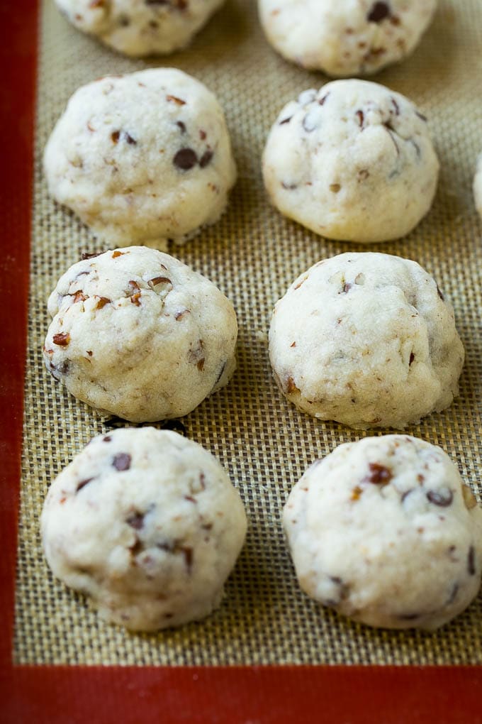 Snowball Cookies Recipe | Mexican Wedding Cookies | Russian Tea Cakes #cookies #pecan #chocolate #baking #dessert #christmas #ezlod Baked snowball cookies on a sheet pan.