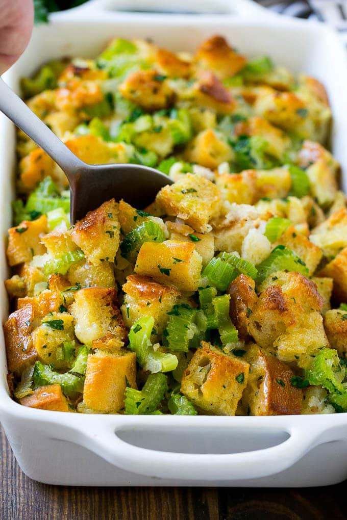 Turkey Stuffing Recipe | Thanksgiving Stuffing | Classic Stuffing #thanksgiving #stuffing #sidedish #fall #ezlod Turkey stuffing in a casserole dish with a serving spoon in it.