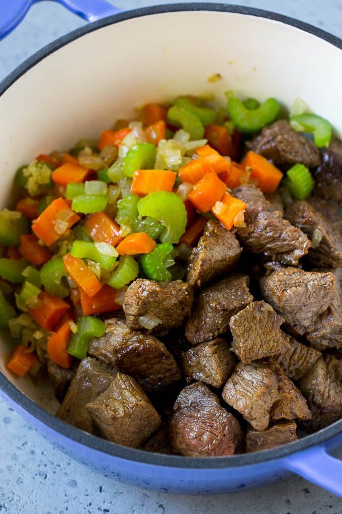 Vegetable Beef Soup Recipe | Beef Vegetable Soup | Beef Soup #beef #veggies #soup #dinner #glutenfree #ezlod Beef stew meat, carrots, onion and celery in a pot.