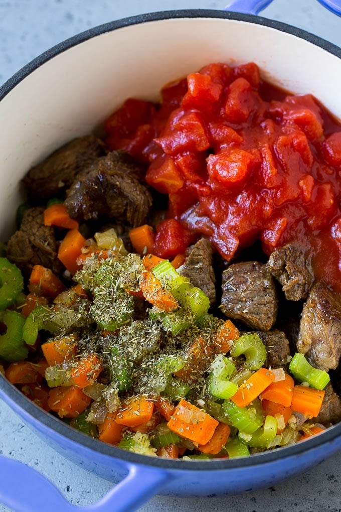 Vegetable Beef Soup Recipe | Beef Vegetable Soup | Beef Soup #beef #veggies #soup #dinner #glutenfree #ezlod Stew meat, veggies, tomatoes and herbs in a pot.