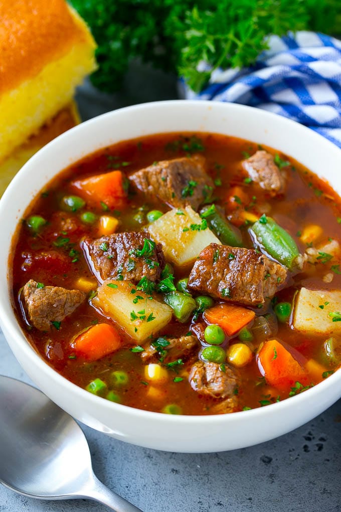 Vegetable Beef Soup Recipe | Beef Vegetable Soup | Beef Soup #beef #veggies #soup #dinner #glutenfree #ezlod A bowl of vegetable beef soup with carrots, celery, onions, potatoes, tomatoes, corn and peas.