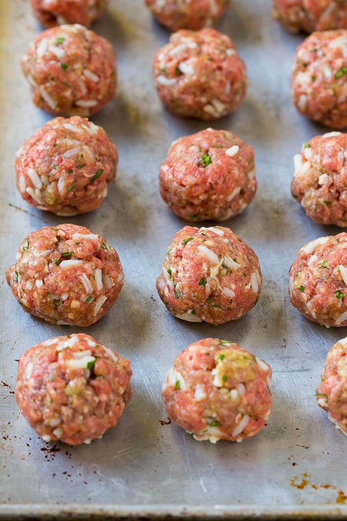 Albondigas Soup | Meatball Soup | Mexican Soup #soup #meatballs #beef #rice #glutenfree #dinner #ezlod #comfortfood Uncooked beef and rice meatballs on a sheet pan.