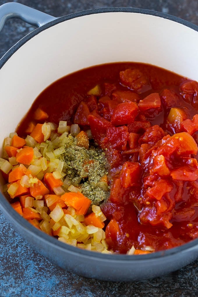 Albondigas Soup | Meatball Soup | Mexican Soup #soup #meatballs #beef #rice #glutenfree #dinner #ezlod #comfortfood Vegetables, tomatoes and herbs in a soup pot.