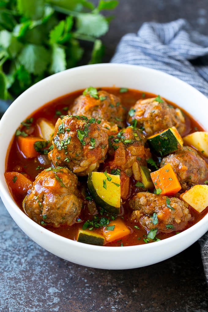 Albondigas Soup | Meatball Soup | Mexican Soup #soup #meatballs #beef #rice #glutenfree #dinner #ezlod #comfortfood A bowl of albondigas soup with meatballs, carrots, zucchini and tomatoes.