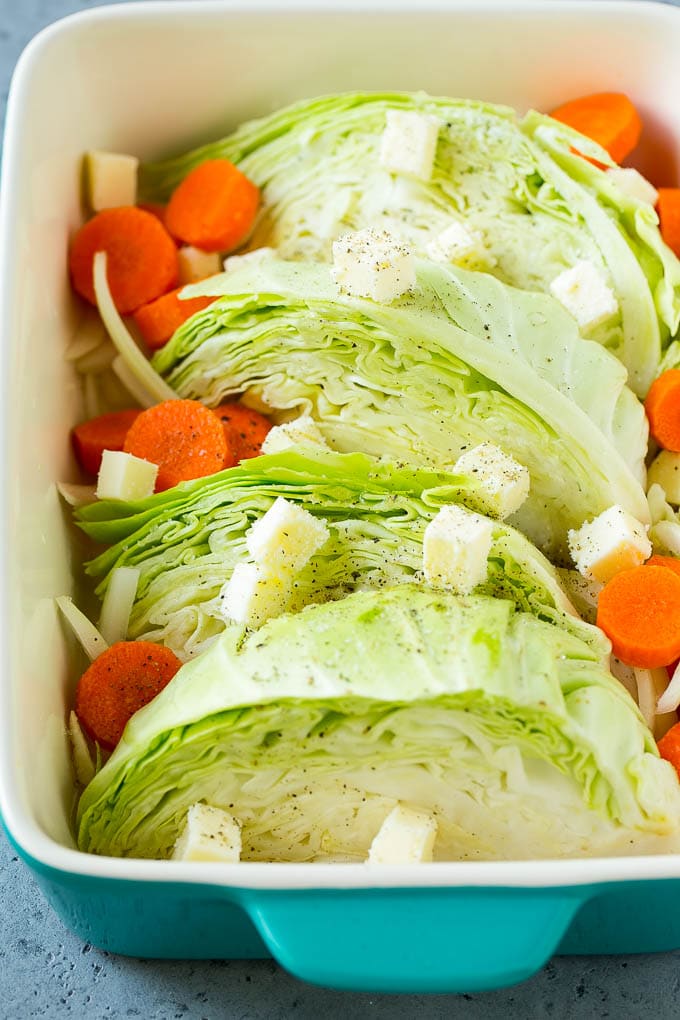 Braised Cabbage Recipe | Easy Cabbage Recipe #cabbage #lowcarb #keto #carrots #veggies #vegetarian #dinner #ezlod Cabbage, carrots, onions, pieces of butter and seasonings in a baking dish.
