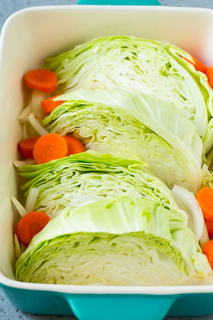 Braised Cabbage Recipe | Easy Cabbage Recipe #cabbage #lowcarb #keto #carrots #veggies #vegetarian #dinner #ezlod Wedges of cabbage, sliced carrots and onion in a baking dish.