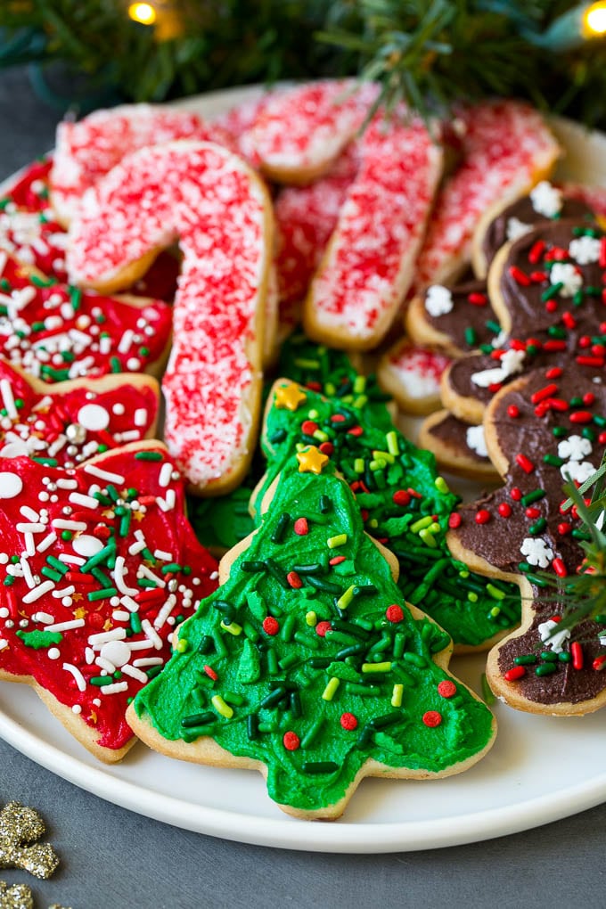 Christmas Sugar Cookies Recipe | Christmas Cookies #cookies #frosting #sprinkles #sugarcookies #christmas #dessert #ezlod A serving plate of Christmas sugar cookies decorated with frosting and sprinkles.