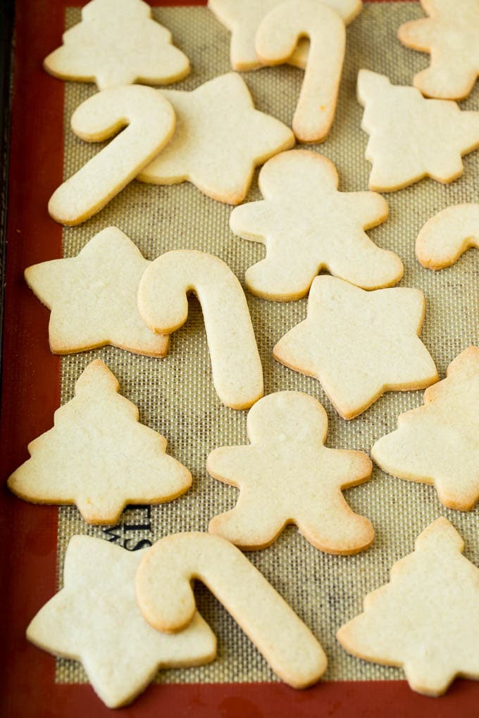 Christmas Sugar Cookies Recipe | Christmas Cookies #cookies #frosting #sprinkles #sugarcookies #christmas #dessert #ezlod Cut out cookies on a sheet pan.