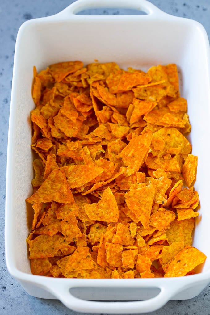 Dorito Casserole Recipe | Mexican Casserole | Beef Casserole #mexicanfood #beef #groundbeef #casserole #dinner #ezlod Crushed nacho chips in the bottom of a casserole dish.