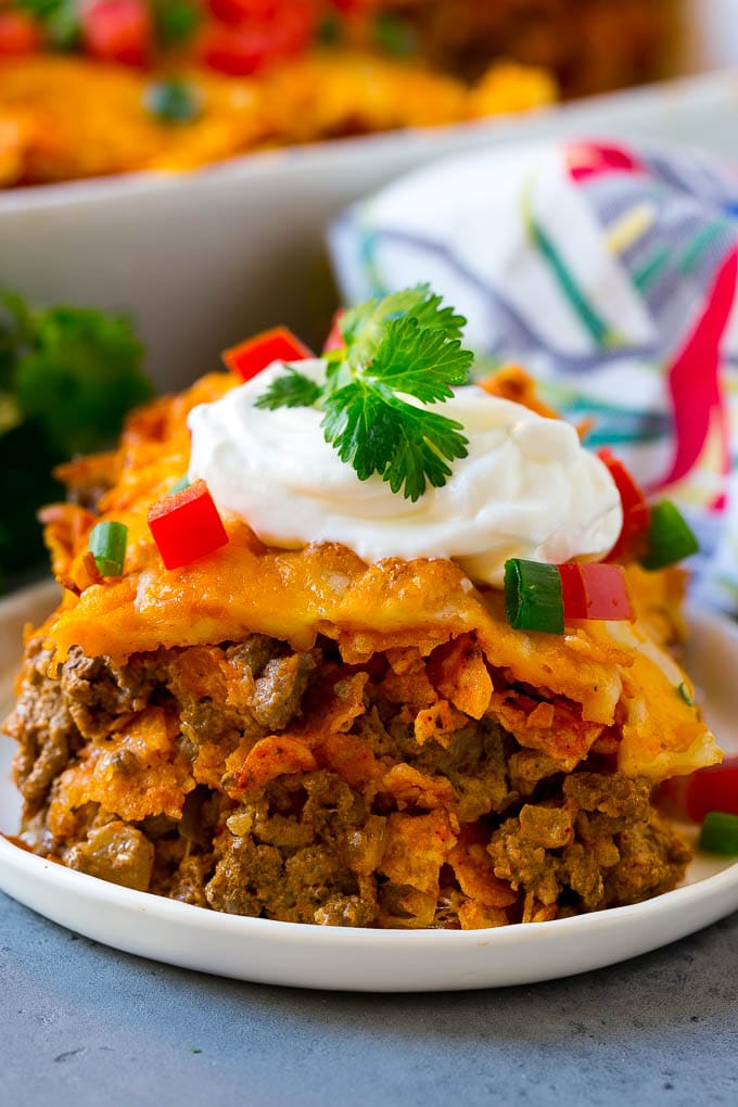 Dorito Casserole Recipe | Mexican Casserole | Beef Casserole #mexicanfood #beef #groundbeef #casserole #dinner #ezlod A piece of Dorito casserole with layers of tortilla chips, beef and cheese.