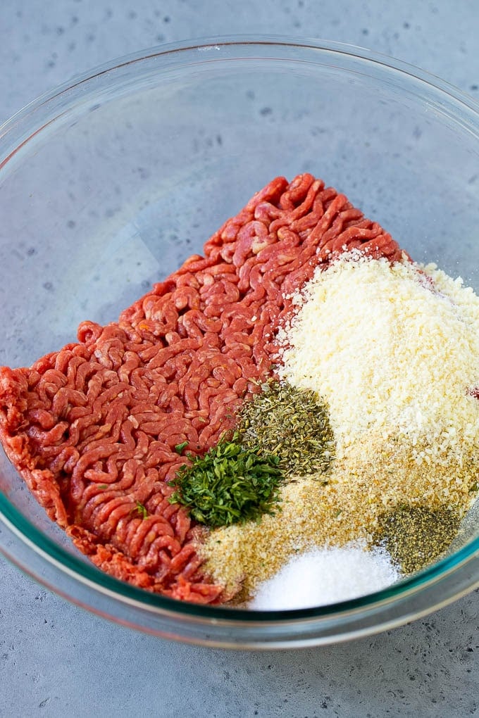Italian Meatball Soup Recipe | Meatball Soup | Beef Meatballs #meatballs #beef #soup #italian #dinner #ezlod #comfortfood Ground beef, breadcrumbs, parsley, herbs and parmesan cheese in a mixing bowl.