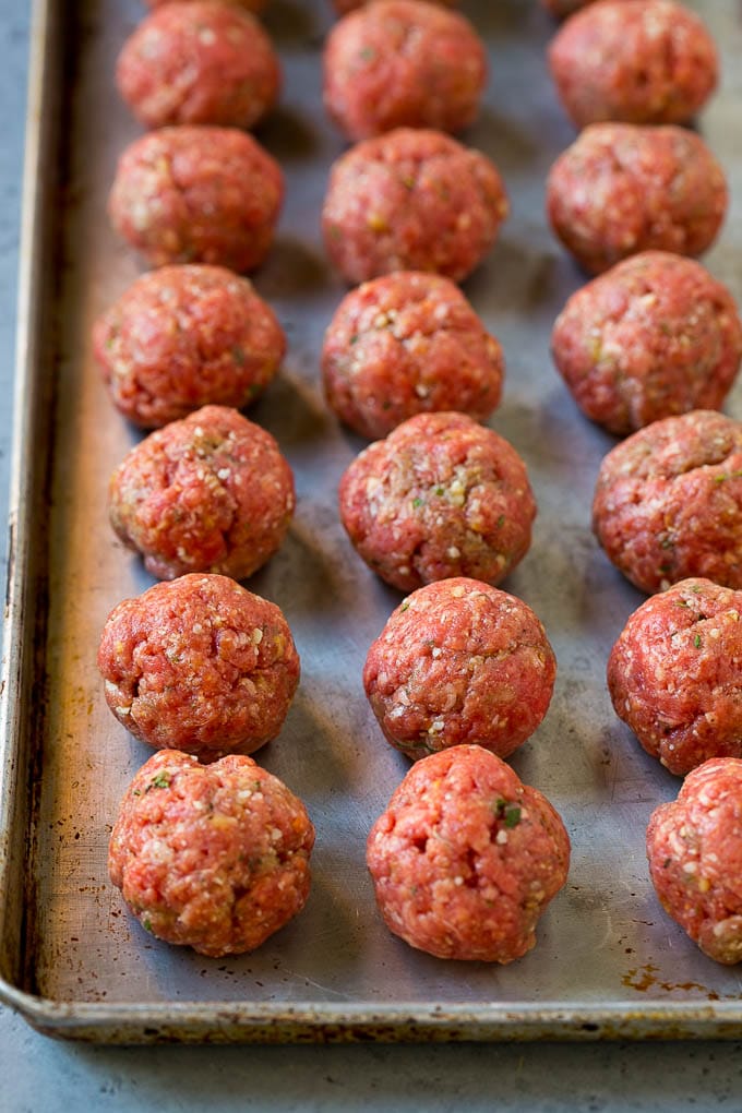 Italian Meatball Soup Recipe | Meatball Soup | Beef Meatballs #meatballs #beef #soup #italian #dinner #ezlod #comfortfood Raw meatballs on a sheet pan ready to go into the oven.