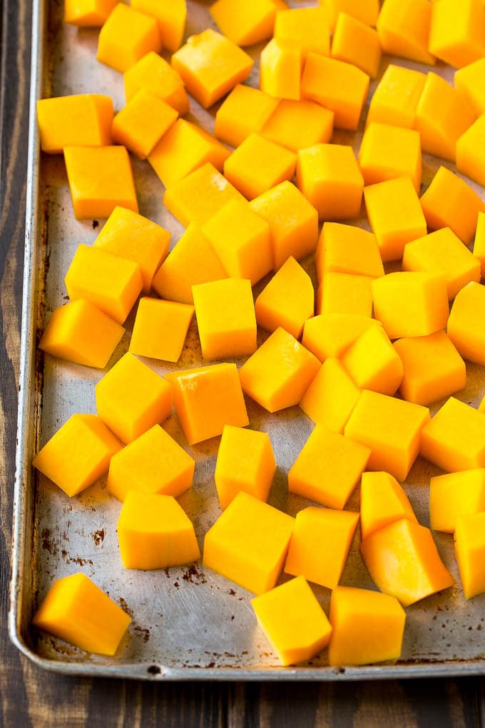 Roasted Butternut Squash Recipe | Baked Butternut Squash | Butternut Squash Side Dish #butternutsquash #squash #fall #vegetarian #dinner #ezlod Raw cubed squash on a sheet pan.