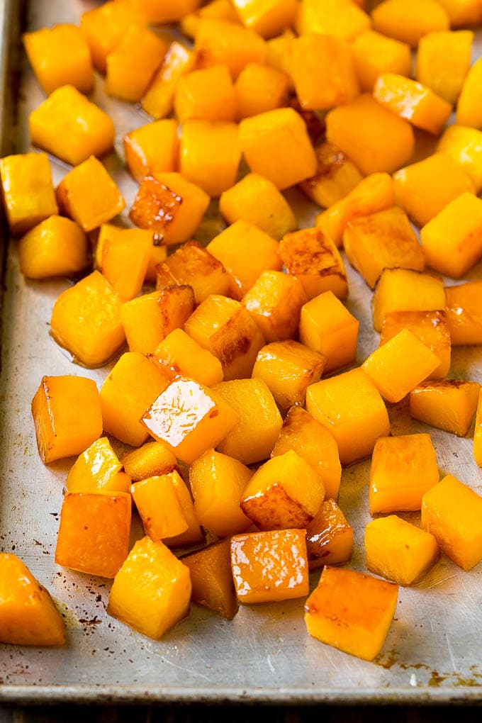 Roasted Butternut Squash Recipe | Baked Butternut Squash | Butternut Squash Side Dish #butternutsquash #squash #fall #vegetarian #dinner #ezlod Caramelized cooked butternut squash on a sheet pan.