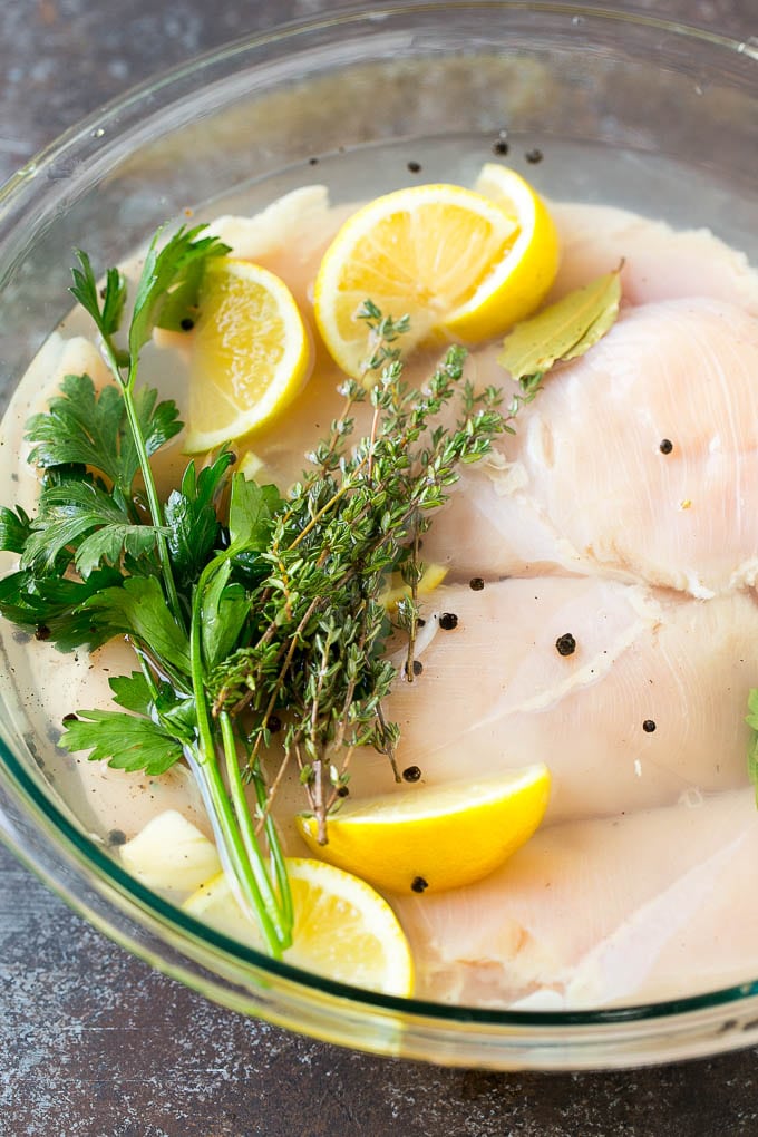 Smoked Chicken Breast Recipe | BBQ Chicken | Smoked Chicken #bbq #chicken #smoker #dinner #glutenfree #ezlod Chicken breasts in a bowl of brine with lemon and herbs.