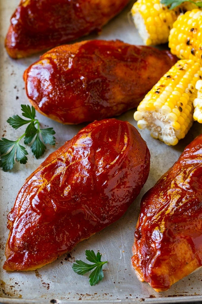 Smoked Chicken Breast Recipe | BBQ Chicken | Smoked Chicken #bbq #chicken #smoker #dinner #glutenfree #ezlod Smoked chicken breasts on a sheet pan with corn on the corn and fresh herbs.