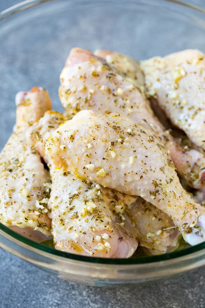 Baked Chicken Drumsticks Recipe | Roasted Chicken Drumsticks | Garlic and Herb Chicken #dinner #chicken #garlic #glutenfree #lowcarb #keto #cleaneating #ezlod A bowl of chicken legs in a garlic and herb marinade.
