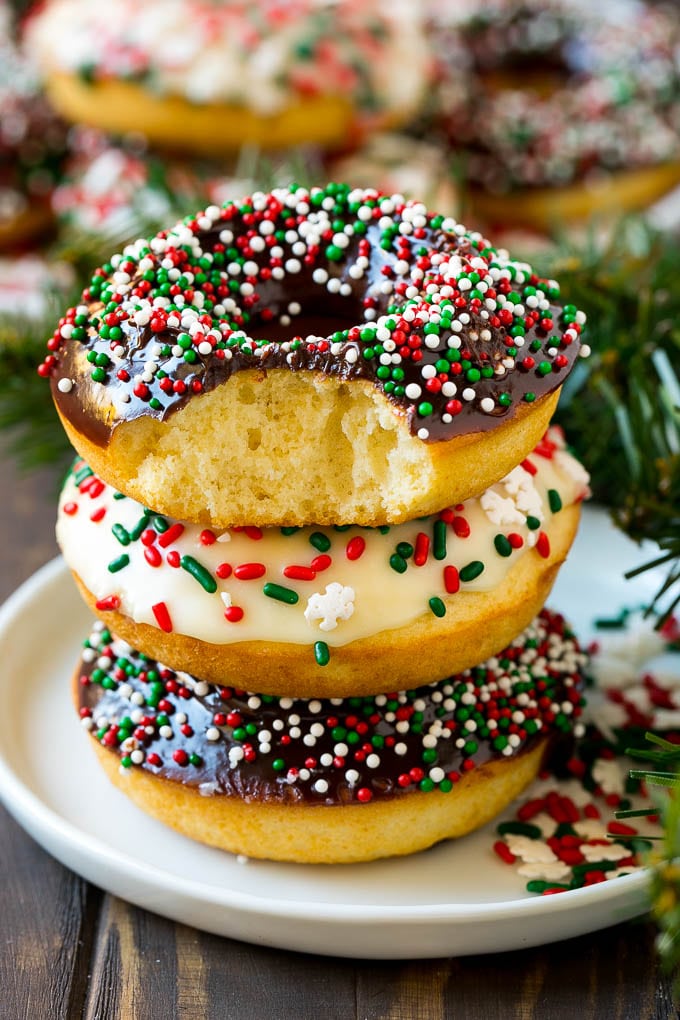 Baked Donuts Recipe | Cake Donuts | Chocolate Donuts | Sprinkle Donuts #donuts #chocolate #sprinkles #breakfast #brunch #ezlod A stack of donuts with a bite out of one.