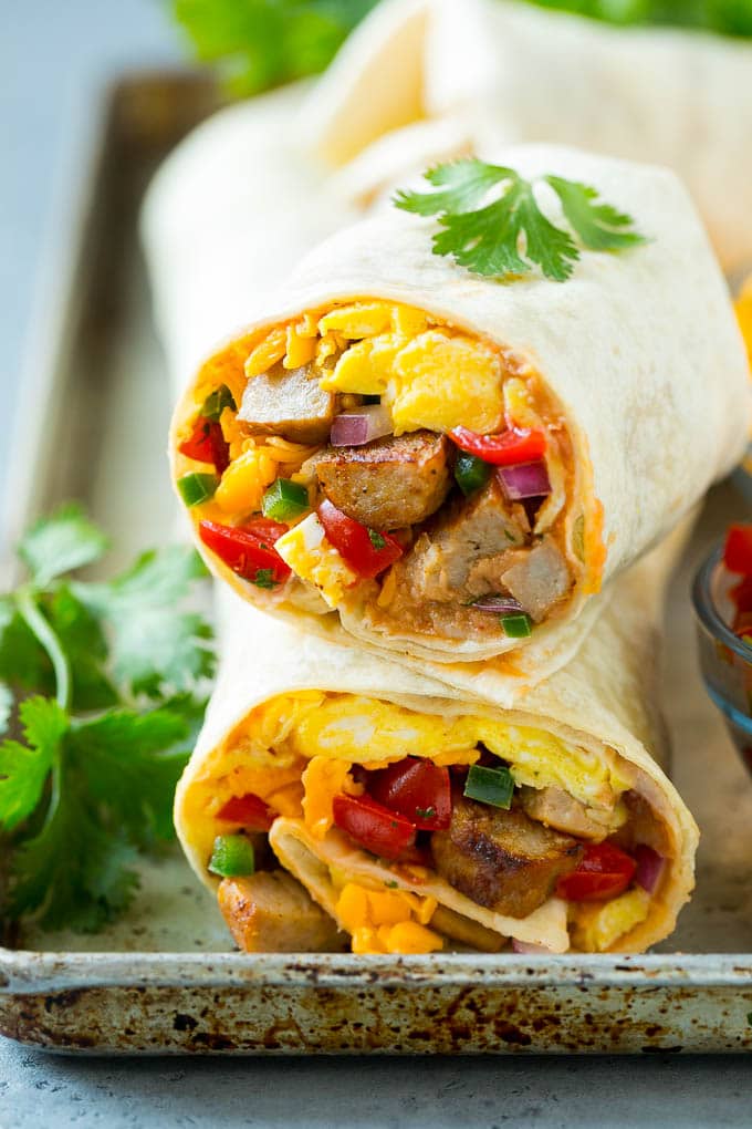 Breakfast Burrito Recipe | Sausage Breakfast Burrito #breakfast #sausage #eggs #burrito #ezlod A cross section of a breakfast burrito filled with eggs, sausage, beans and cheese.