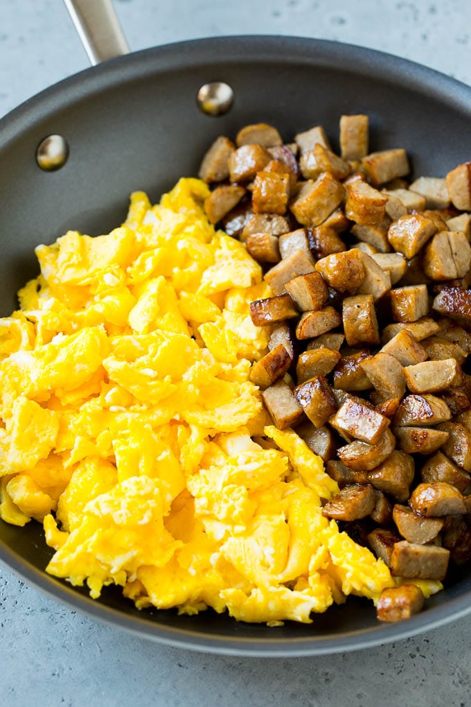 Breakfast Burrito Recipe | Sausage Breakfast Burrito #breakfast #sausage #eggs #burrito #ezlod Diced sausage and scrambled eggs in a pan.