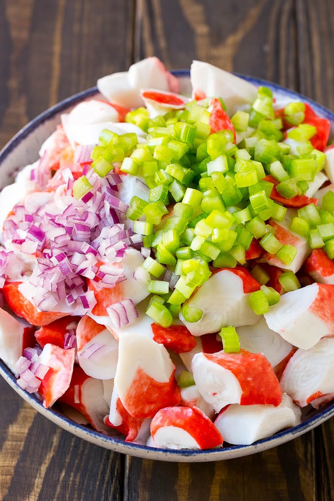 Crab Salad Recipe | Seafood Salad | Deli Salad #crab #salad #seafood #lowcarb #keto #lunch #dinner #ezlod Imitation crab, celery and red onion in a serving bowl.