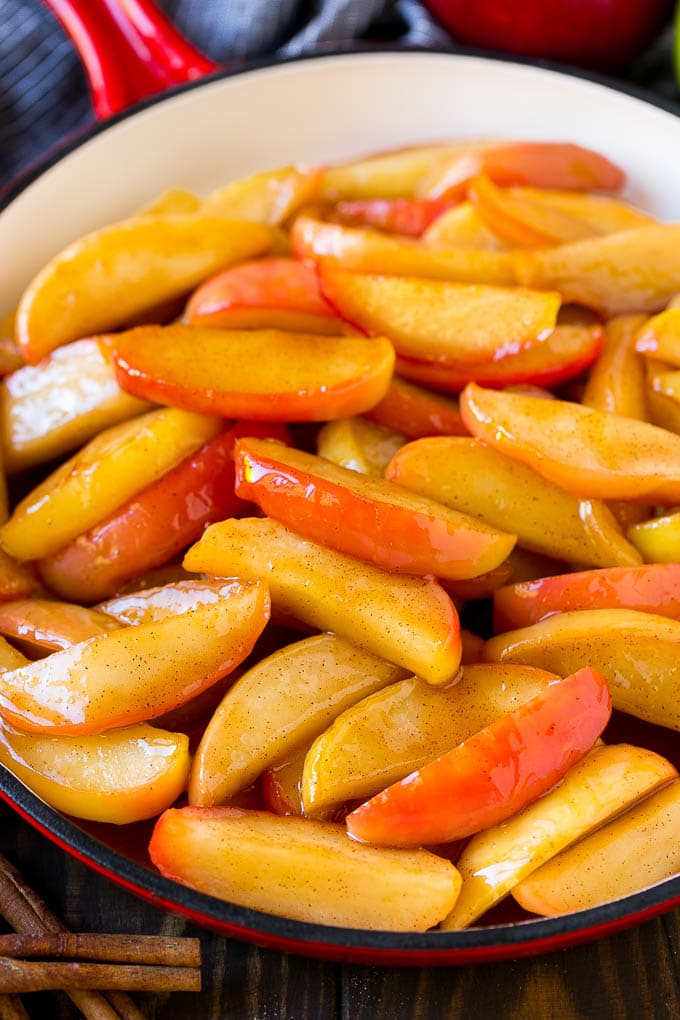 Fried Apples Recipe | Sauteed Apples | Cinnamon Sugar Apples #apples #cinnamon #sugar #sidedish #dessert #ezlod #fall Southern fried apples coated in butter, cinnamon and sugar in a red skillet.