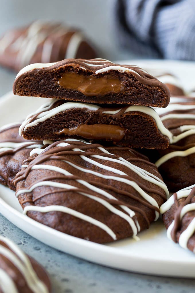 Nutella Cookies Recipe | Nutella Stuffed Cookies | Chocolate Cookies #nutella #chocolate #cookies #baking #dessert #ezlod A serving plate of Nutella cookies with one cut in half.