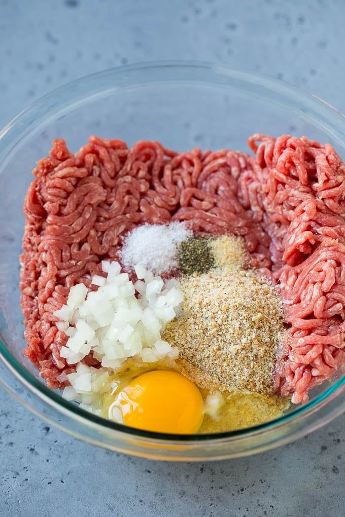 Sweet and Sour Meatballs Recipe | Slow Cooker Meatballs | Crockpot Meatballs | Cocktail Meatballs #meatballs #beef #slowcooker #crockpot #dinner #appetizer #ezlod Ground beef, onion, breadcrumbs and seasonings in a bowl.