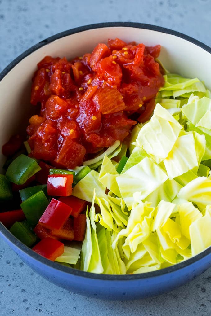 Cabbage Soup Recipe | Vegetable Soup | Veggie Soup | Healthy Soup #soup #healthy #cleaneating #cabbage #vegetables #veggies #dinner #ezlod Red and green peppers, diced tomatoes and raw veggies in a large pot.