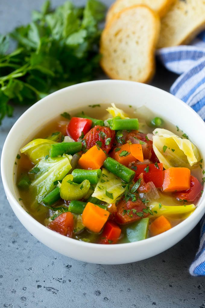 Cabbage Soup Recipe | Vegetable Soup | Veggie Soup | Healthy Soup #soup #healthy #cleaneating #cabbage #vegetables #veggies #dinner #ezlod A bowl of cabbage soup with carrots, celery and tomatoes in broth.