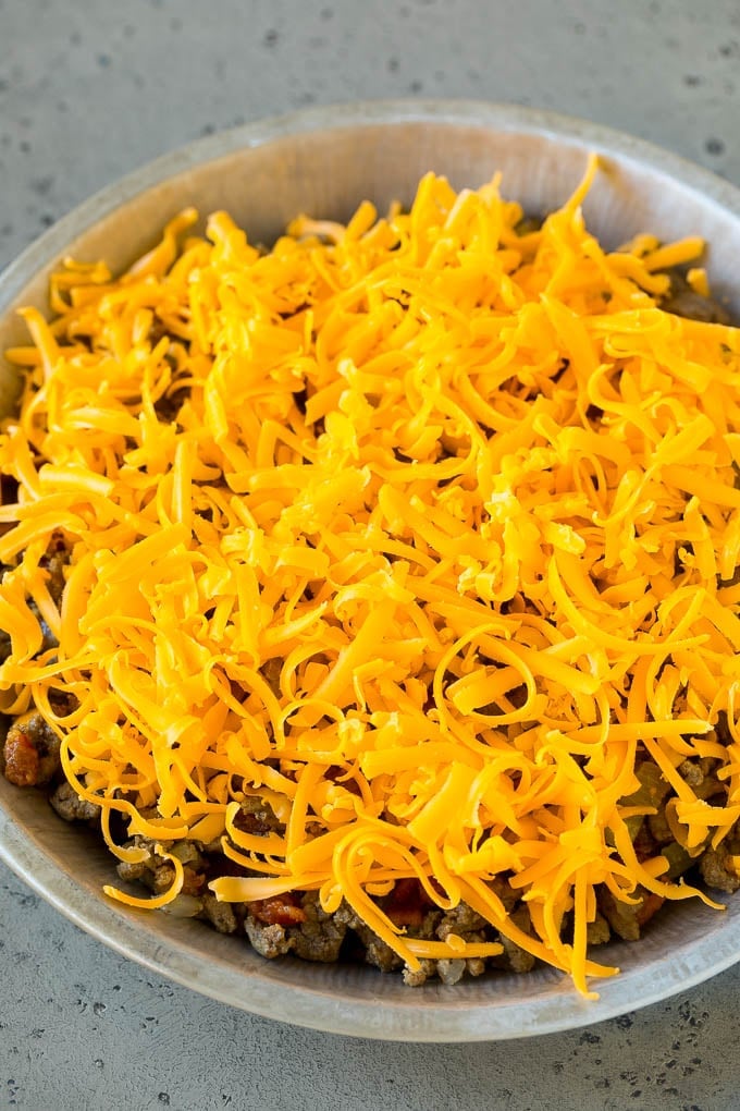 Cheeseburger Pie Recipe | Cheeseburger Casserole | Ground Beef Recipe #cheeseburger #beef #bacon #cheese #casserole #dinner #ezlod Ground beef and shredded cheddar cheese in a dish.