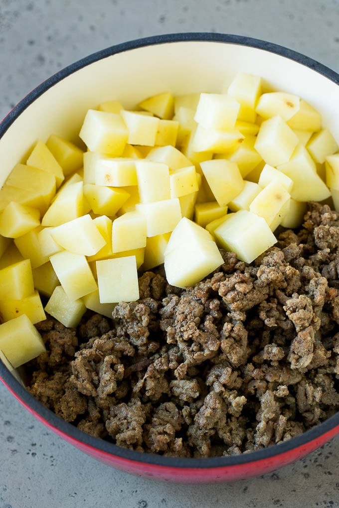 Cheeseburger Soup Recipe | Hamburger Soup | Cheese Soup #soup #groundbeef #hamburger #cheese #bacon #dinner #ezlod Cooked ground beef and potatoes in a pot.