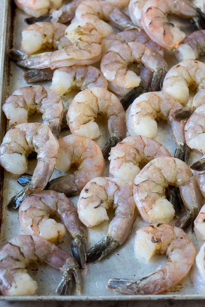 Coconut Shrimp Recipe | Fried Shrimp | Shrimp Appetizer #shrimp #coconut #appetizer #seafood #dinner #ezlod Large raw tail-on shrimp arranged on a sheet pan.