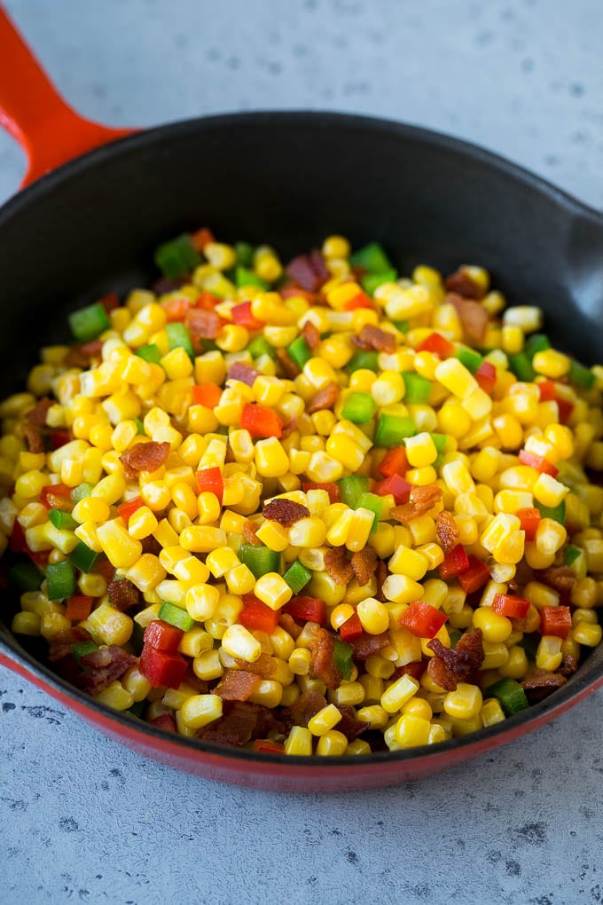 Corn Dip Recipe | Hot Cheese Dip | Bacon Dip #corn #dip #bacon #cheese #appetizer #snack #ezlod Corn, bacon and bell peppers in a skillet.