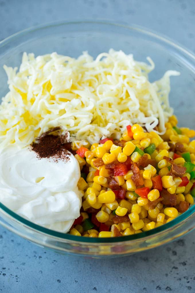 Corn Dip Recipe | Hot Cheese Dip | Bacon Dip #corn #dip #bacon #cheese #appetizer #snack #ezlod Corn, bacon, bell peppers, sour cream and cheese in a mixing bowl.