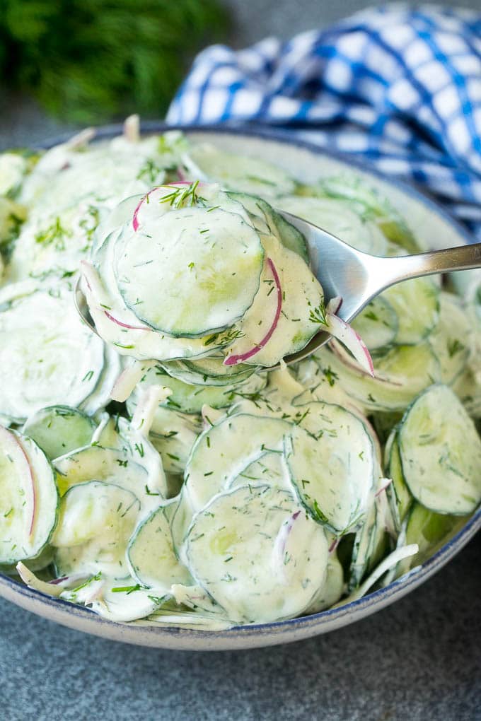 Creamy Cucumber Salad Recipe | German Cucumber Salad | Cucumber Salad #cucumber #salad #dinner #lunch #ezlod #cucumbersalad A spoon serving up a portion of creamy cucumber salad.