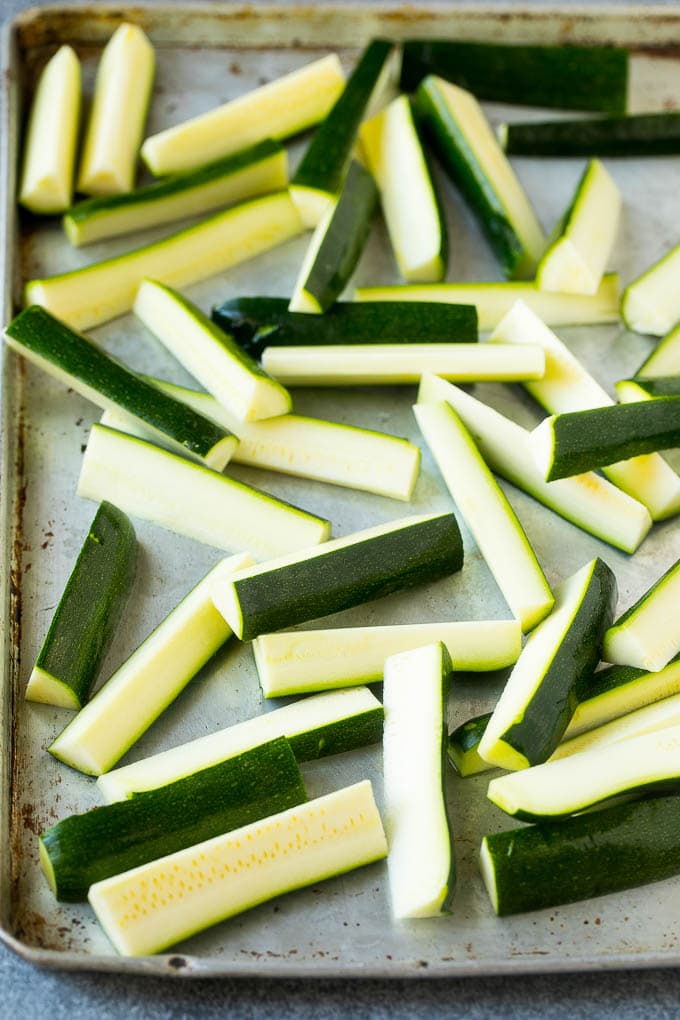 Fried Zucchini Recipe | Zucchini Fries | Zucchini Recipe #appetizer #zucchini #snack #ezlod Raw sticks on a sheet pan.