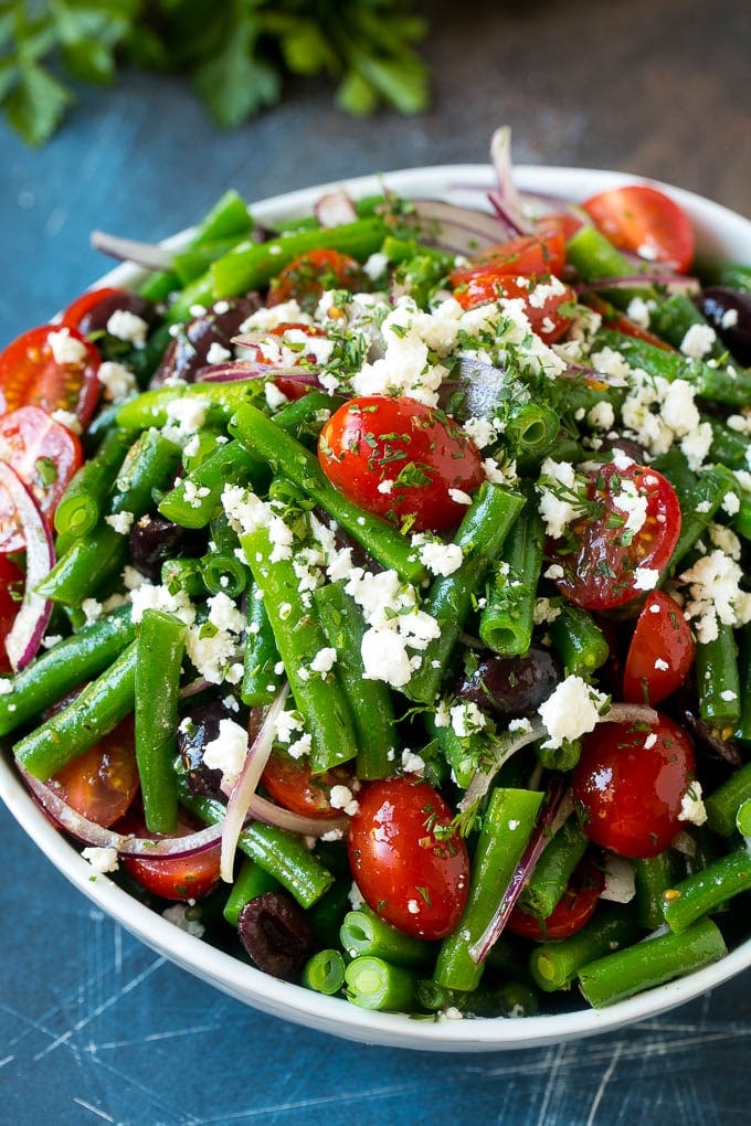 Green Bean Salad Recipe | String Bean Salad | Chopped Salad #greenbeans #tomatoes #olives #salad #cleaneating #lowcarb #glutenfree #ezlod A bowl of green bean salad made with feta cheese, tomatoes, red onion and kalamata olives.