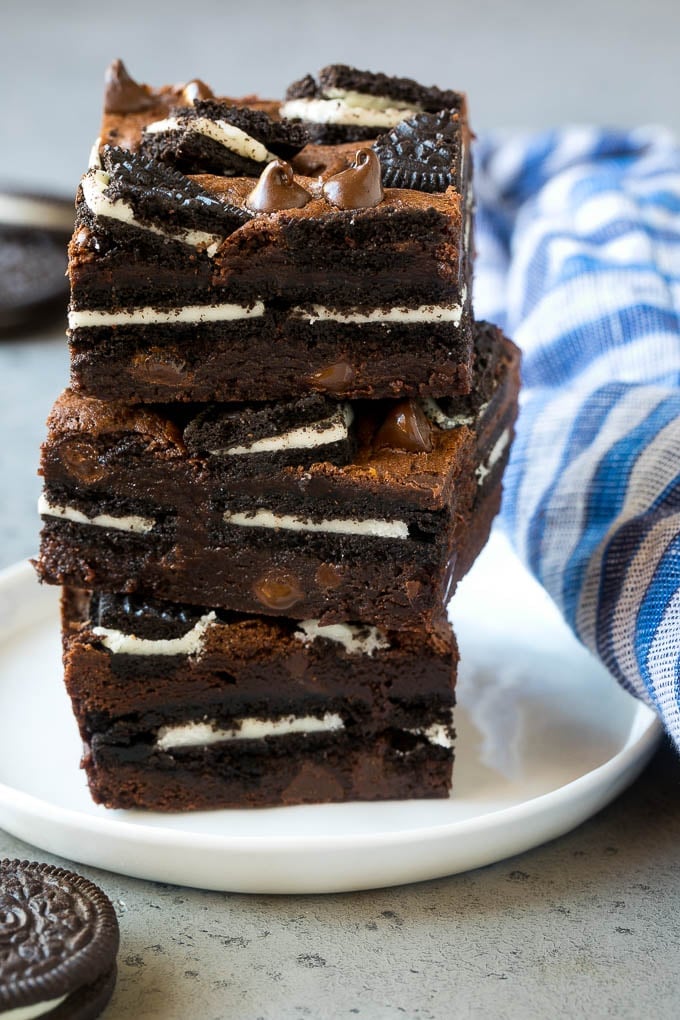 Oreo Brownies Recipe | Homemade Brownies | Chocolate Chip Brownies #brownies #oreos #chocolate #dessert #sweets #ezlod A stack of Oreo brownies filled with sandwich cookies and chocolate chips.