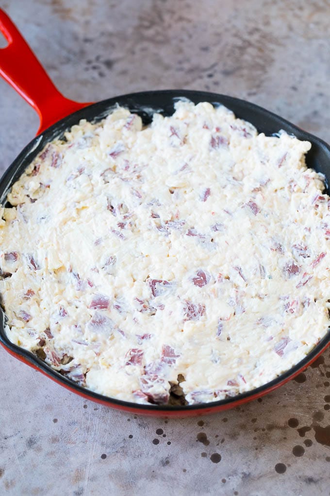 Reuben Dip Recipe | Corned Beef Dip | Cheese Dip #dip #cheese #cornedbeef #appetizer #lowcarb #keto #ezlod Cream cheese, corned beef and other ingredients spread into a skillet for baking.