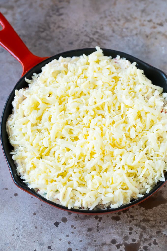 Reuben Dip Recipe | Corned Beef Dip | Cheese Dip #dip #cheese #cornedbeef #appetizer #lowcarb #keto #ezlod A skillet of dip topped with shredded cheese.