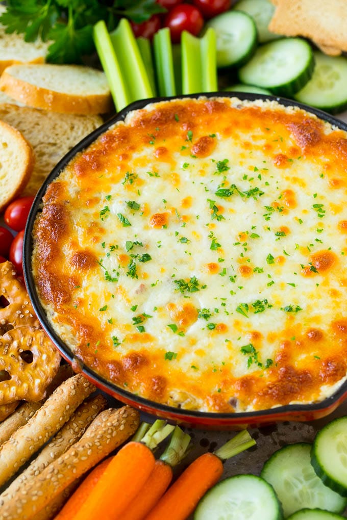 Reuben Dip Recipe | Corned Beef Dip | Cheese Dip #dip #cheese #cornedbeef #appetizer #lowcarb #keto #ezlod Baked Reuben dip in a skillet served with crackers and vegetables.