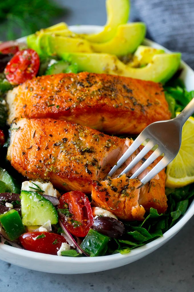 Greek Salmon Salad Recipe | Low Carb Salmon Recipe | Salmon Salad #salmon #seafood #fish #lowcarb #keto #lunch #ezlod #healthy A fork cutting into a salmon fillet in Greek salmon salad.