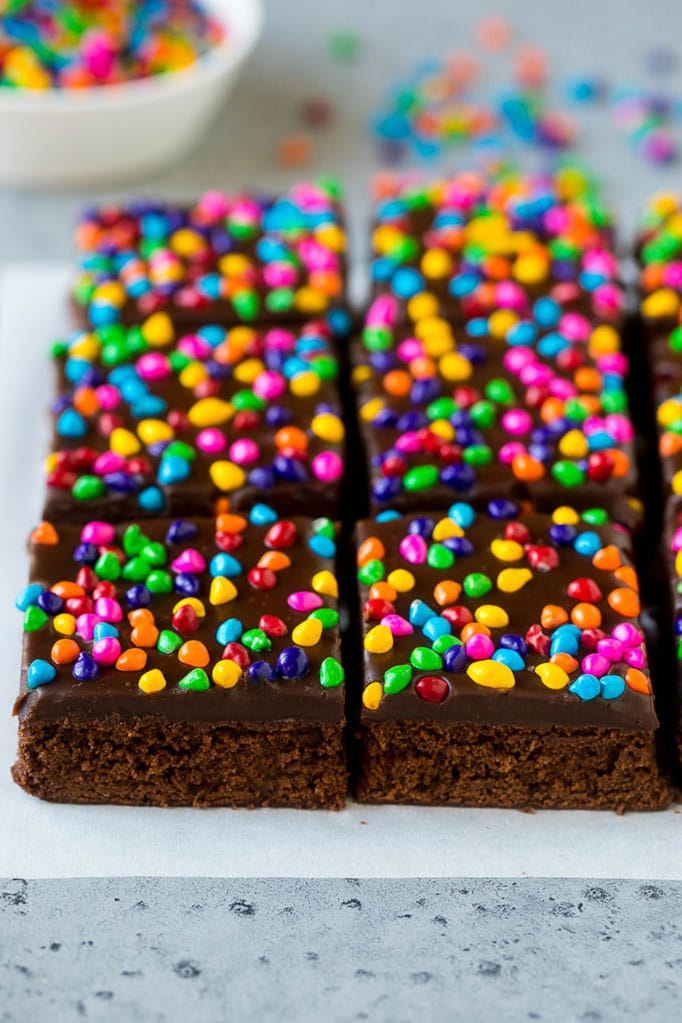 Cosmic Brownies Recipe | Cocoa Brownies | Frosted Brownies #brownies #chocolate #dessert #ezlod #sprinkles Cosmic brownies topped with chocolate fudge and crunchy rainbow sprinkles.
