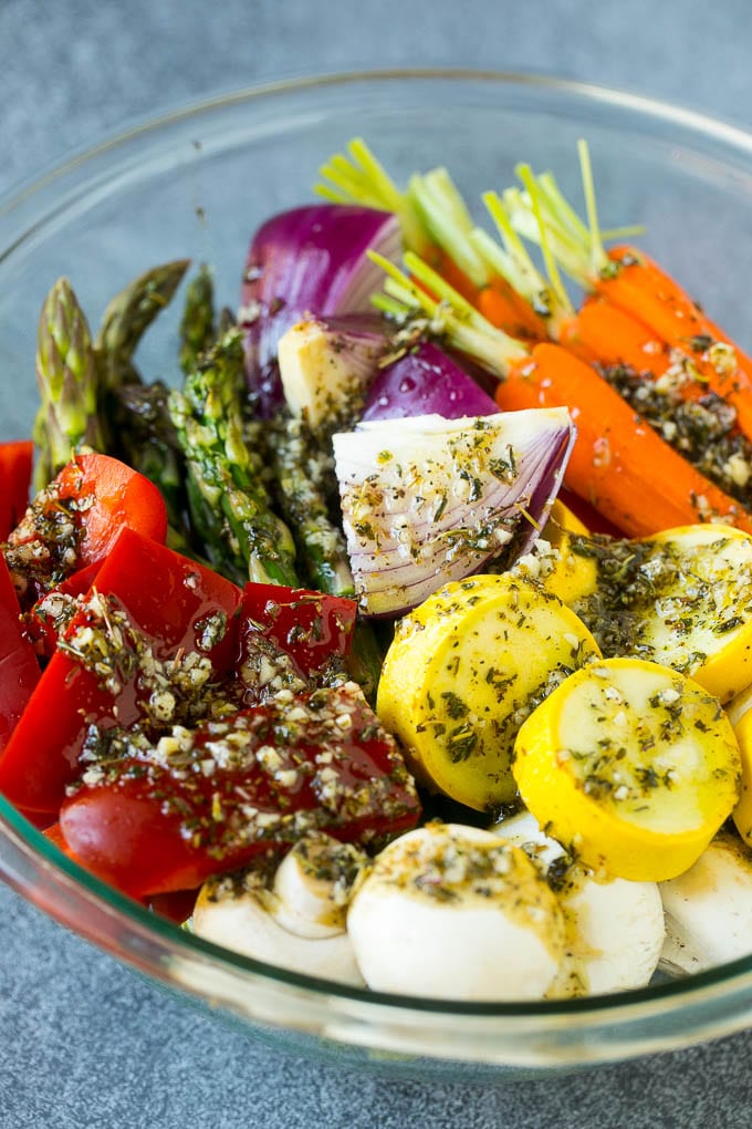 Grilled Vegetables Recipe | Marinated Vegetables | Grilled Veggies #vegetables #veggies #grilling #glutenfree #lowcarb #keto #dinner #ezlod #cleaneating #healthy Raw veggies in a bowl with garlic, herbs and olive oil.