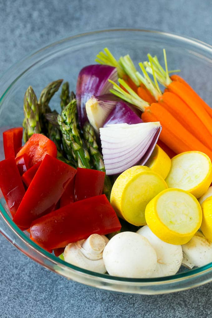 Grilled Vegetables Recipe | Marinated Vegetables | Grilled Veggies #vegetables #veggies #grilling #glutenfree #lowcarb #keto #dinner #ezlod #cleaneating #healthy Carrots, peppers, squash, mushrooms and asparagus in a mixing bowl.