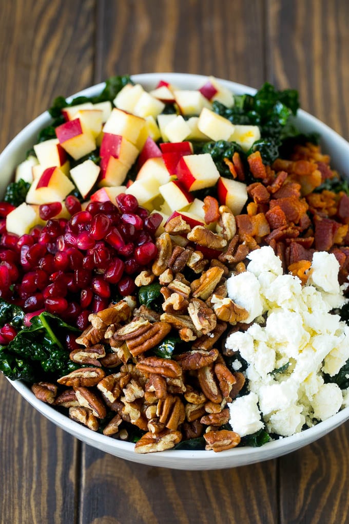 Apple Kale Salad Recipe | Kale Recipe | Fall Salad #kale #apples #bacon #salad #feta #dinner #lunch #ezlod Kale salad topped with apples, bacon, pecans, pomegranate and feta cheese.
