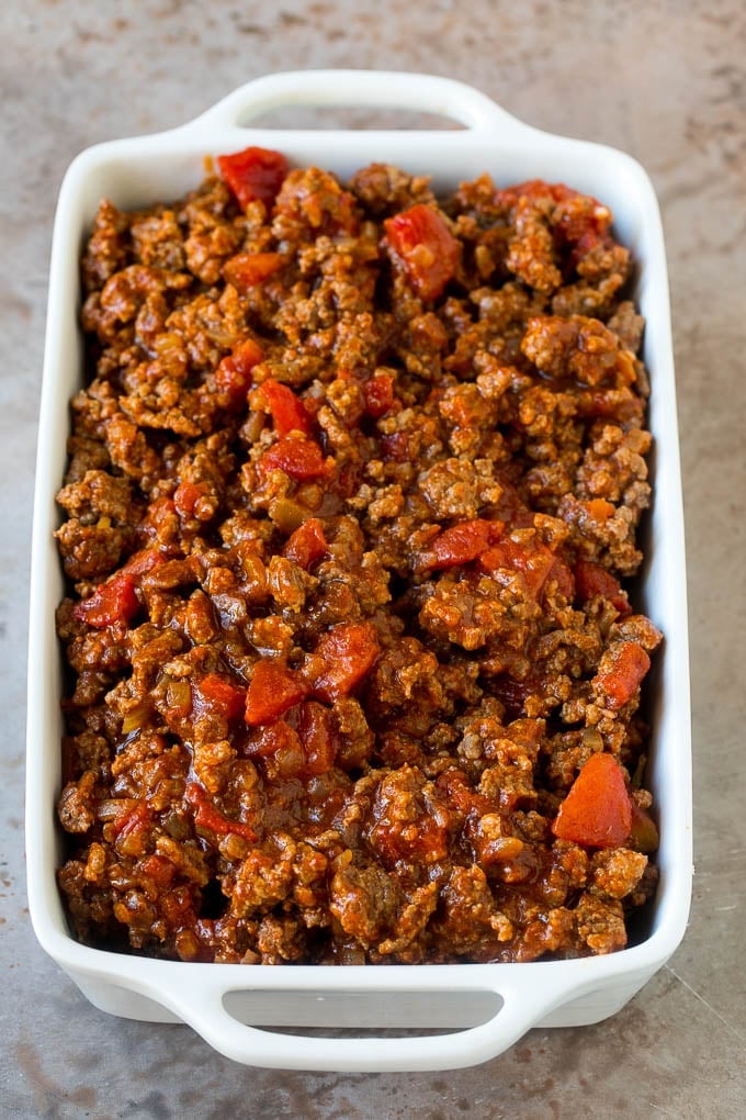 Taco Casserole Recipe | Mexican Casserole | Beef Casserole #casserole #tacos #beef #dinner #cheese #ezlod Cooked taco meat in a casserole dish.