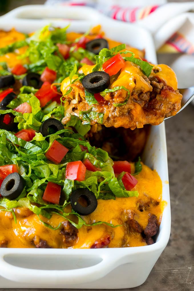Taco Casserole Recipe | Mexican Casserole | Beef Casserole #casserole #tacos #beef #dinner #cheese #ezlod A spoon serving up a portion of beef taco casserole.